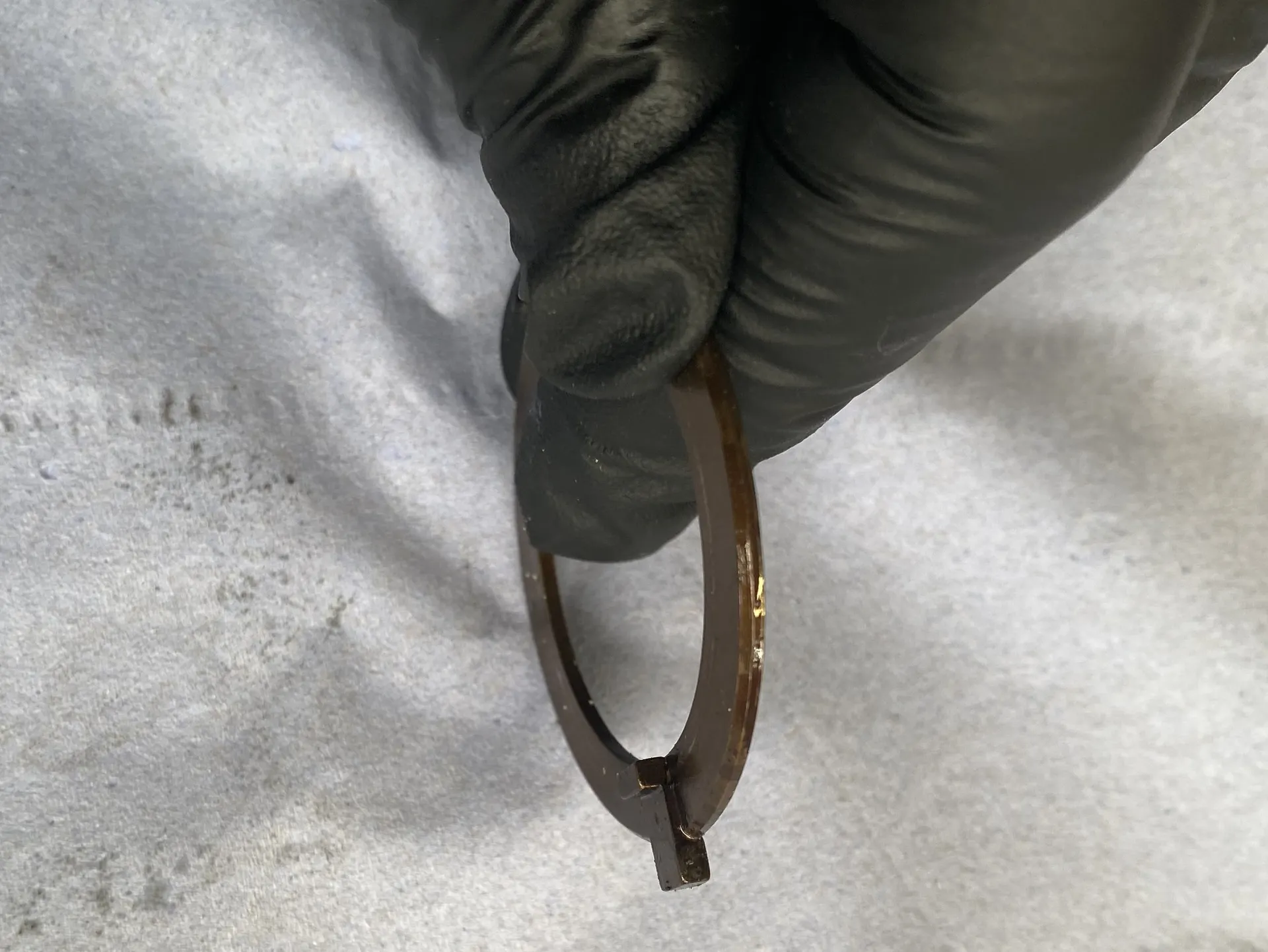 Angled new thrust plate showing the anti-rotation tab contour