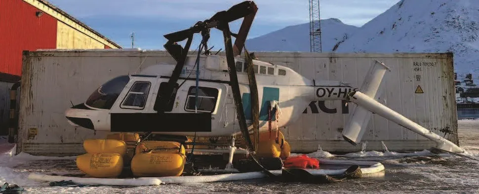 The helicopter with damages on the quay at Narsaq harbour